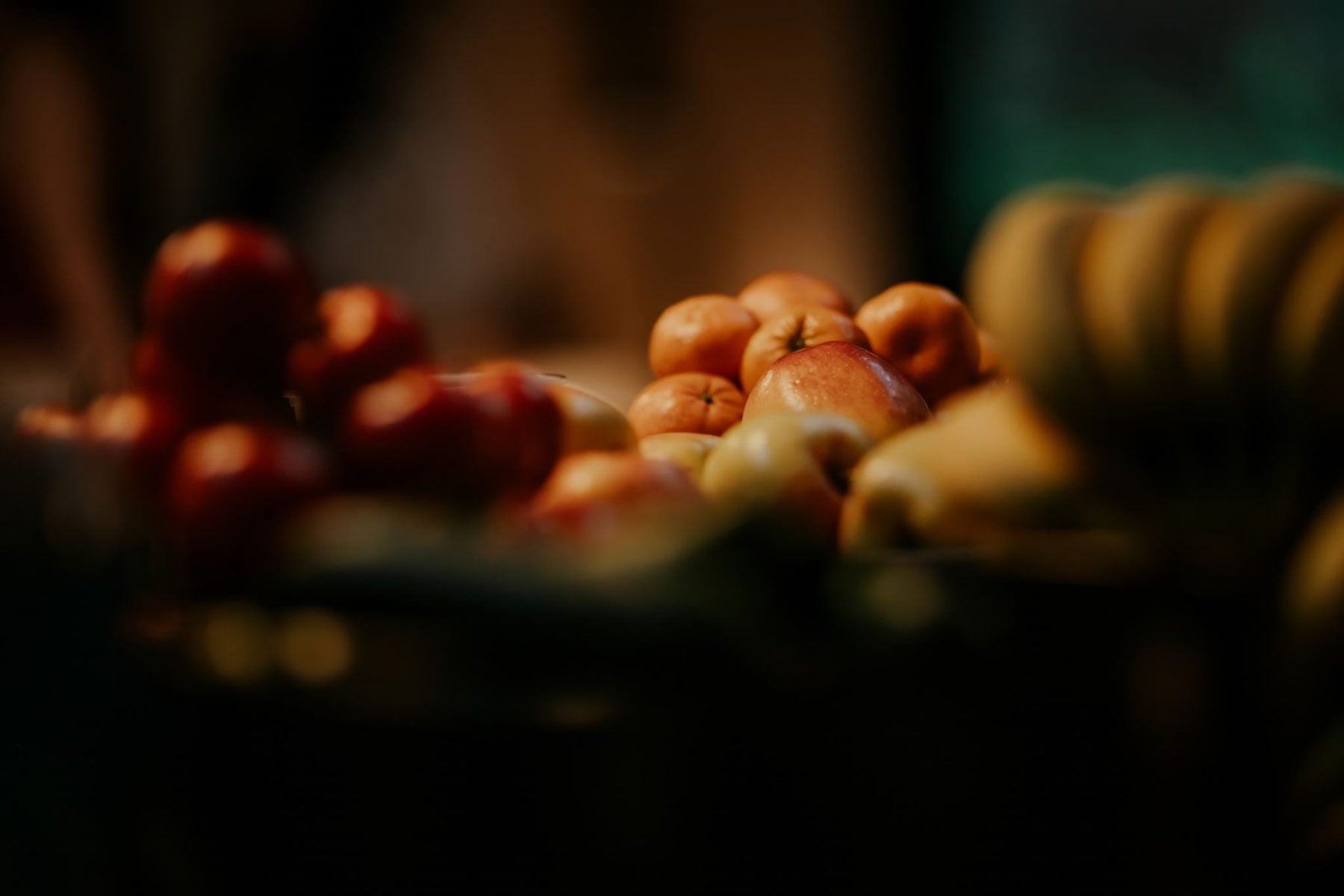 Apples, mandarins and squash piled on a table
